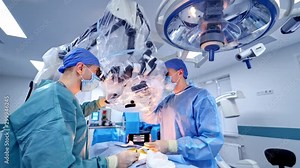 Operation through new microscope in hospital. Two surgeons perform surgery in the neurosurgical department using modern equipment.