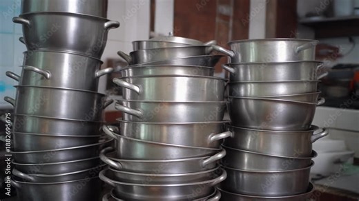 The Stack of Empty Suhoor Pots. Islamic Culture – Idul Fitri. Stack of pots and pans in the kitchen, signaling the temporary end of the nightly Suhoor ritual and the transition to the day of feasting.