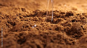 Textured ground coffee backdrop featuring Arabica Natural Bean. Infuse hot water onto the Arabica ground coffee for the preparation of a fresh and aromatic coffee drink