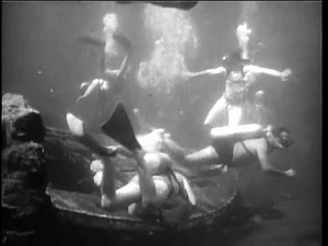 clip-3478735013-undersea-view-scuba-divers-exploring-shipwreck-1960s