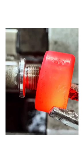 MindBlown Hub on Instagram: "The video showcases an insert overmolding process on a lathe machine, where a heated eye bolt is encapsulated with red molten polymer to form an insulating plastic cap, a common manufacturing step for ergonomic or protective hardware components. Posted January 29, 2026, by Jerryzx_ —a account specializing in satisfying industrial clips—the post exploded to 1 million views and 600 replies within 24 hours, driven by its hypnotic visuals of heat, flow, and precision mac