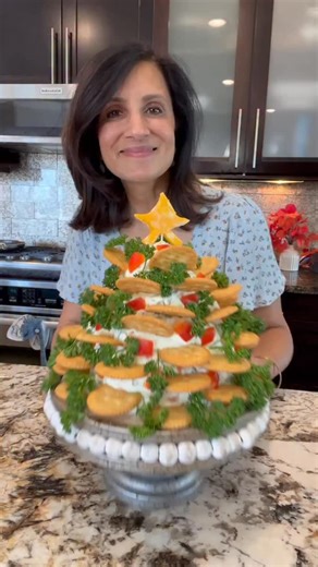 Holiday Ritz Cracker Cream Cheese Appetizer Tree Ingredients * 1 large RED Bell Pepper small dice * 1 large GREEN Bell Pepper small dice * 2 medium Carrots peeled and grated * 4 Green Onions white and green, chopped * 1 large Stalk of Celery small dice * five 8 oz. blocks Cream Cheese (or VEGAN cream cheese alternative) * 1 small star Marbled Cheese cut into a star shape (or VEGAN cheese alternative) * 1 bunch Curley Parsley * Ritz crackers 1. Mix first 6 intens in a mixer . Reserve some of the 