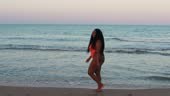 woman with overweight and obese, walking on beach in swimsuit. Summer...