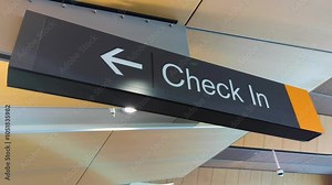 Passenger check in flashing sign with directional arrow at airport terminal