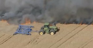 Watch one crazy farmer stop a huge fire with his tractor