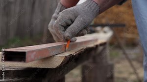 use a ruler to measure the distance in a carpentry workshop