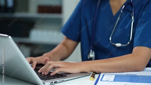 Doctor working with a laptop computer search for medical information at the hospital office.
