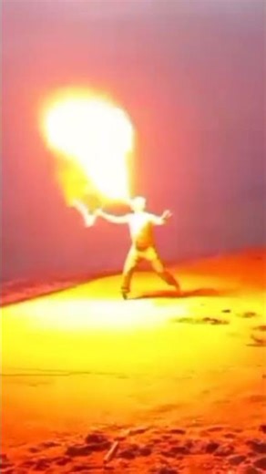 fire staff juggling on the beach's waves