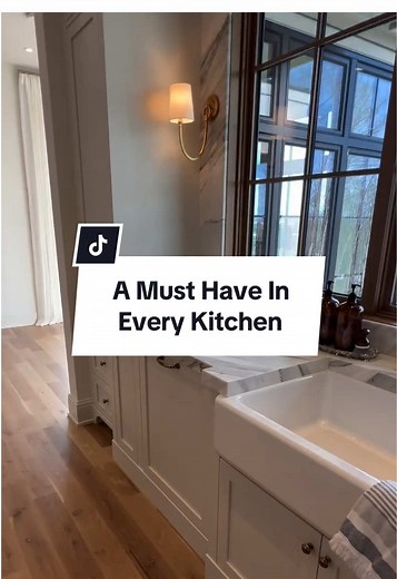 In every kitchen we design and build, there’s one must-have feature that we always include: a pull-out trash and recycling cabinet next to the sink. This thoughtful addition keeps your kitchen clean and organized while maintaining the seamless elegance of the space. The convenience of having your waste and recycling easily accessible yet tucked away is a game changer. #homeorganization #kitchenorganization #kitchendesign #kitchenideas #dreamkitchen