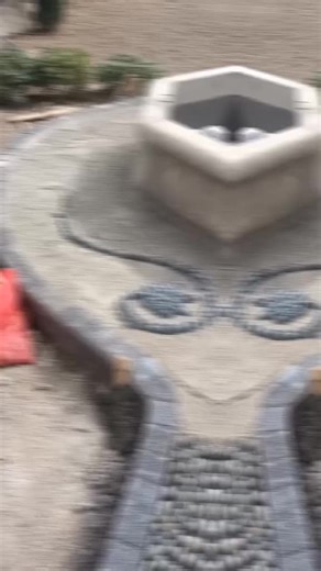 Decorative Pebble Mosaic Creation in Outdoor Spaces