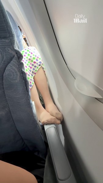 Fury as plane passenger sticks 'smelly' feet on travellers arm rest