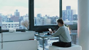 Smart casual woman checking multimedia files with financial statistic information doing distance job in home apartment, Caucasian female analyzing graph diagrams from modern touch pad