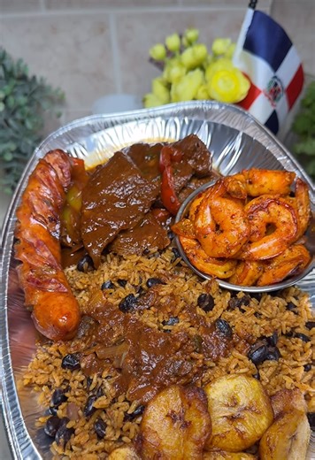 Dominican dinner with family: Steak guisado, moro rice, shrimp, and fried sausage