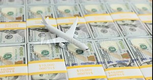 Stacks of 100 dollar bills with a model airplane