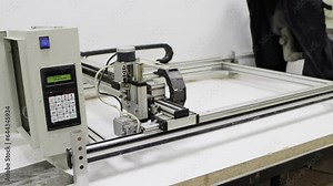 a modern production machine for applying inscriptions and photographs on a tombstone, close-up