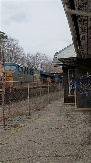 Csx m631 passes an old depot with a friendly crew #train #csx