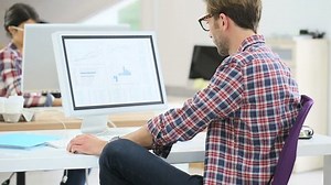 clip-10382666-office-worker-working-on-desktop-computer