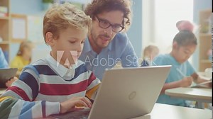 Elementary School Computer Science Class: Smart Boy Uses Laptop Computer, Friendly Teacher Helps Him by Explaining Lesson. Children Getting Modern Education in STEM, Playing and Learning