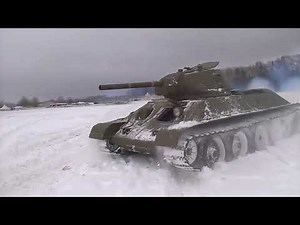WW2 T-34-76 Tank moves through the snow.