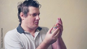 science and technology.humorous look.research and discovery concept.emotional curious scientist.portrait of a funny researcher looking at a test tube filled with substance