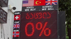 A Currency Exchange/ Bureau de Change board showing Dollars, Euros and other currency values on a high street