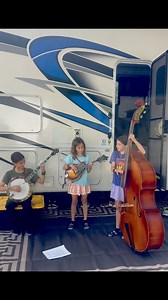 Jamming by the RV! The girls squeezed in a little bluegrass before the next leg of the trip—barefoot, in flip-flops, and totally in the groove. RV life has its moments, and this was one of them. Thanks for following our journey! #BluegrassFamily #SisterBand #RVLife #MandolinMoments #BanjoBreak #UprightBassGroove #AlaskanSunnysideSisters #foryoupageシ #fypviralシ # | Alaskan Sunnyside Sisters