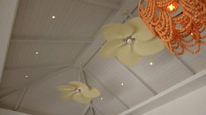 Explore the Stylish Ceiling Design that incorporates Fans and Unique Lighting Elements