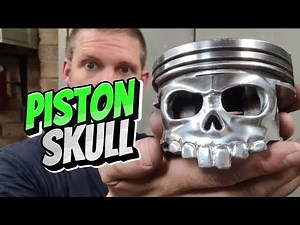 A piston carved into a skull, using a dremel.