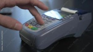 Swiping a credit card to pay at the store.