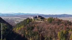 Aerial drone view of The Rasnov Fortress in Romania. Medieval fortress on the top of the hill, village near it