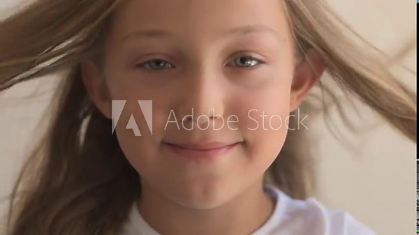 Close Up Portrait of happy young girl with blue eyes and blond hair. Standing on Wind. Breeze is playing with girl's hair. Stormy weather, autumn, winter, spring. Old style vintage. Shallow focus