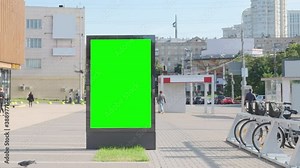 Empty billboard with a green screen for advertising on the city square.