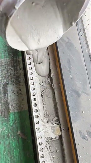 pouring liquid cement into a window frame to fill gaps and ensure a solid installation