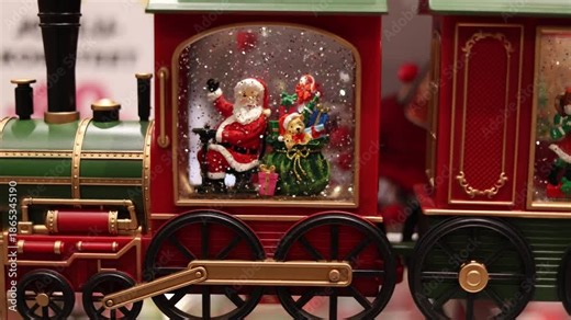 Beautiful Christmas souvenir toy train with Santa Claus inside sparkling glitter flying festive holiday atmosphere cozy winter decoration