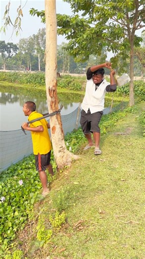 The man exercises by hanging from a tree