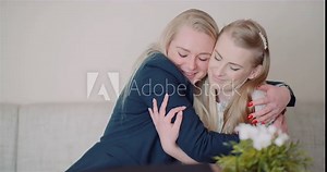Two Happy Sisters Hugging Together and Giving Support to Each Other Smiling Into Camera