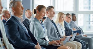 Senior Caucasian Woman Sitting in Crowded Audience at a Business Conference. Female Top Manager Smiling, Using Laptop Computer. Specialist Watching Presentation About Investing In Innovative Startups.