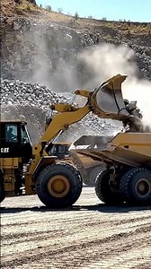 26#Caterpillar 992K Wheel Loader Loading Blasted Rocks Onto CAT 777F Dumpers At Aggregate Quarry