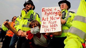London climate protesters glue themselves to train as 300 arrested