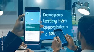 A dedicated team of developers collaborates on coding and testing software for a new mobile application in a modern office environment. This scene captures the dynamic and intricate process Stock Video