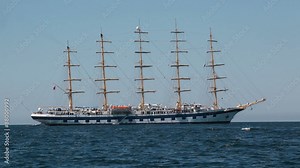 Large sailing ship with five masts anchored in the open sea.