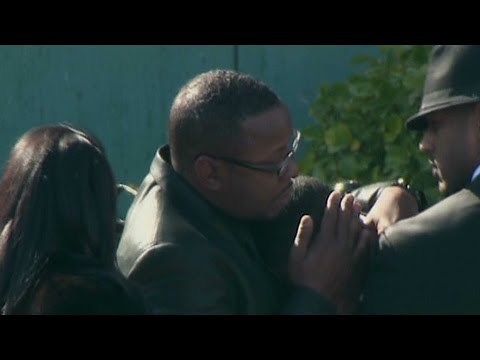 Whitney Houston Funeral - Bobby Brown comforts friend at funeral