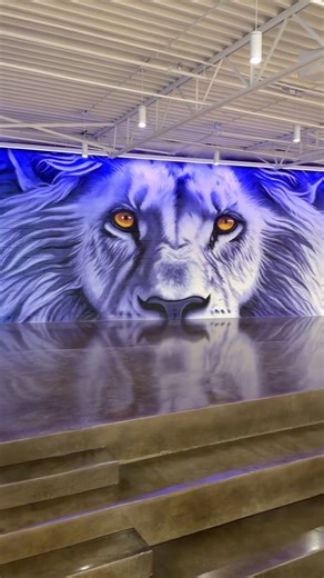Noah Henderson on Instagram: "A bit different than my typical canvas painting. About 25 cans of a spray paint and over 500 square feet later I painted a lion I am so proud of. I am honored to have been given the privilege to paint this lion at my highschool @cpalions. Such a fun project to work on and could not be happier with how it turned out. #mural #lionmural #spraypaintart #animalmural"