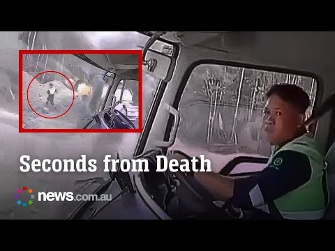 Driver leaps to safety as truck is dragged into landslide at mine in Indonesia