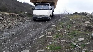 Balancing Hay on a White Van: A Rocky Journey