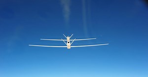 Global Hawk UAVs fly in close formation as part of aerial refueling program