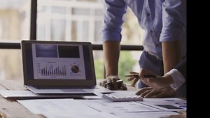 在办公桌前协作、分析财务图表和使用计算器进行有效决策的商务人员