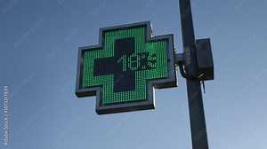 Illuminated information sign on the cross of an on-call pharmacy selling medicines. Concept: Trade, traders, medicine.