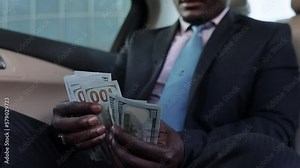 Counting paper money. Close-up of a man's hands counting dollar bills. The concept of earnings and business profitability. Benefit, profit and salary for a major purchase or acquisition,