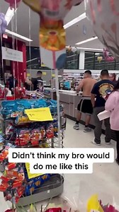 Guy rips his brother's shirt off in the checkout line!